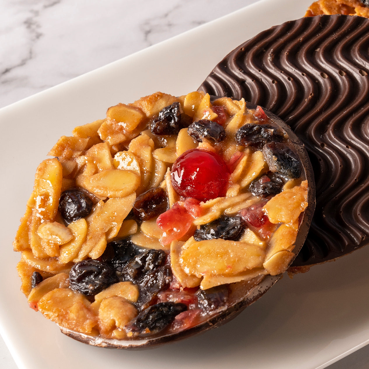 Bryson's famous Chocolate Florentines, made with almonds, cherries and raisins in a caramel toffee mix. The other side is covered in a layer of Belgian Chocolate.