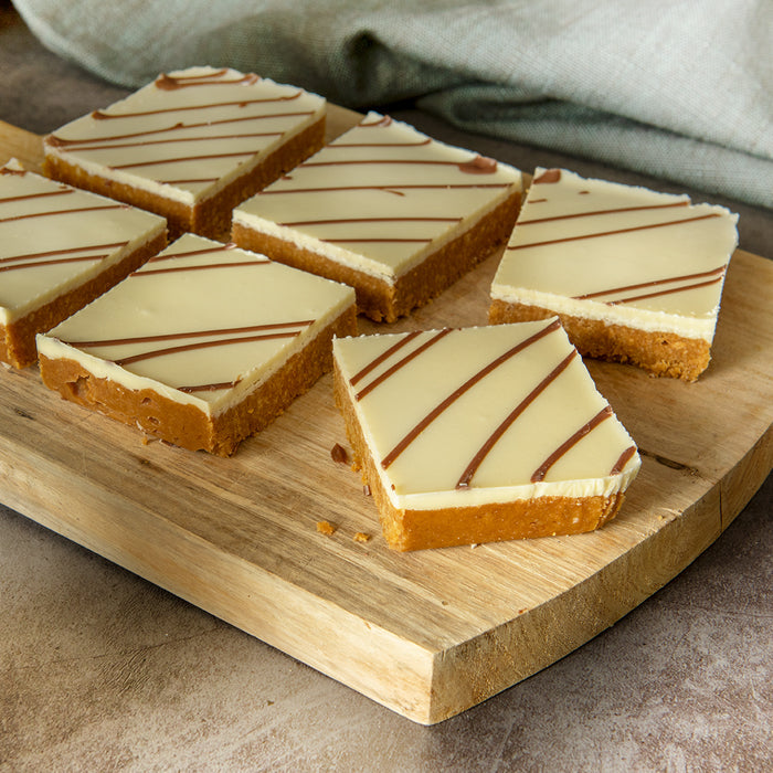 6 Bryson's Caramel Tiffin Slices on a chopping board. 